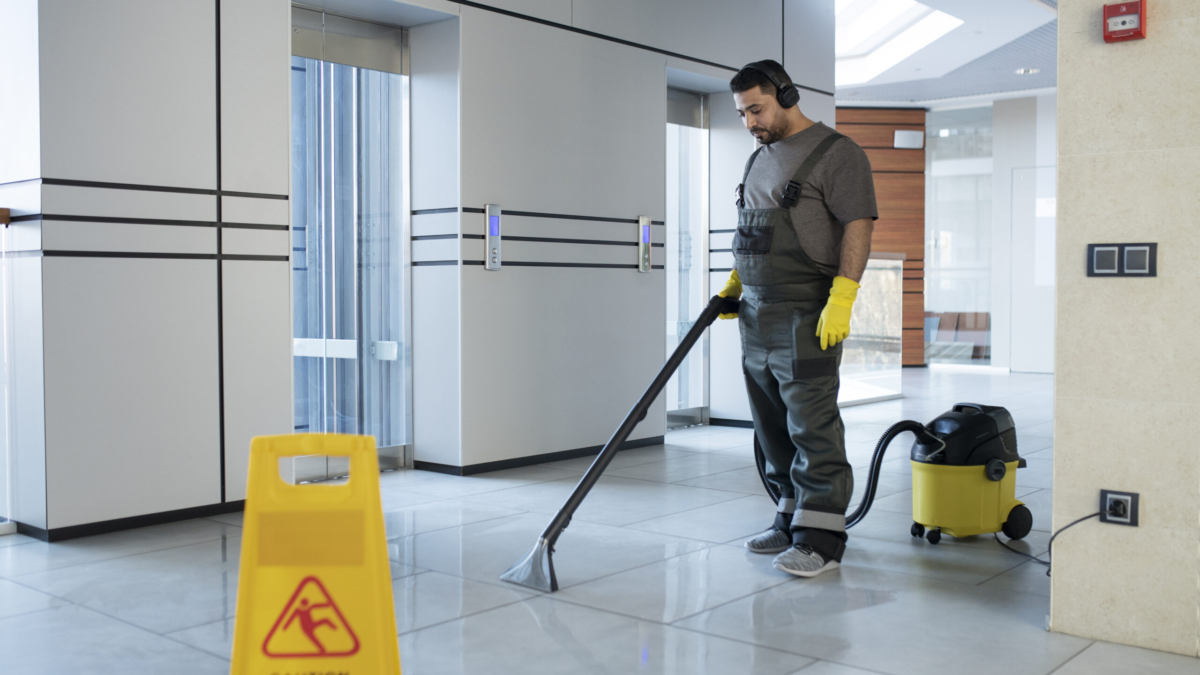 full-shot-man-vacuuming-floor